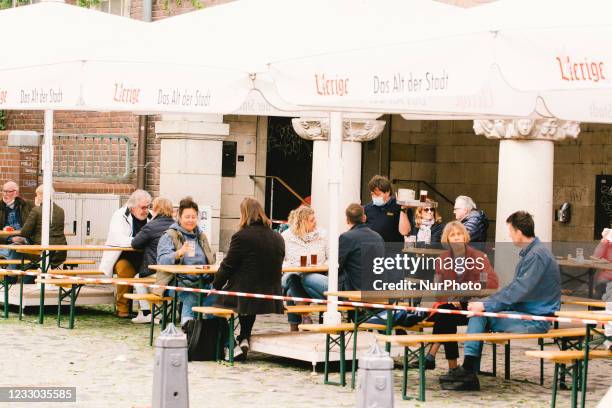 People enjoys beer at Uerige, a popular beer house in Duesseldorf, Germany on May 21, 2021 as Duesseldorf reopens the outdoor dinning to easing of...