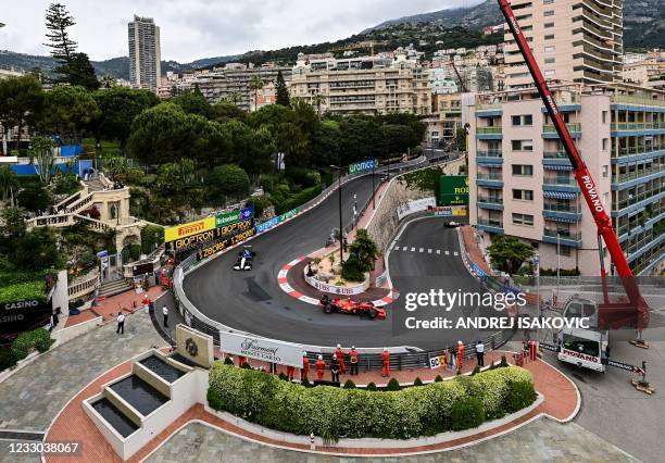 Ferrari's Spanish driver Carlos Sainz Jr drives followed by Williams' British driver George Russell during the third practice session at the Monaco...