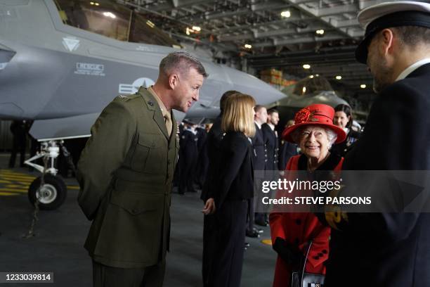 Britain's Queen Elizabeth II meets military personnel during her visit to the aircraft carrier HMS Queen Elizabeth in Portsmouth, southern England on...