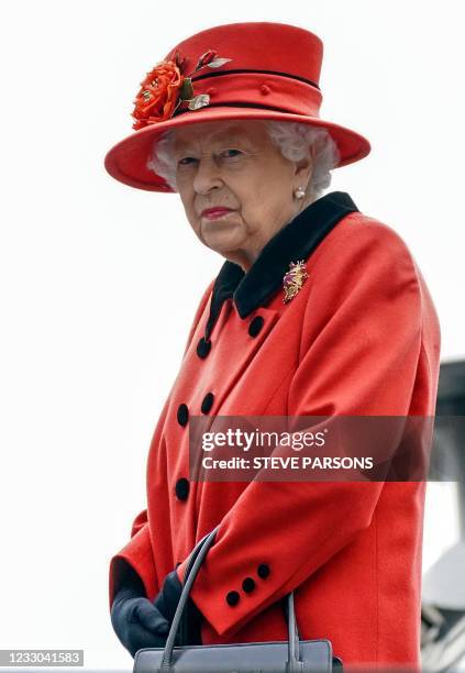 Britain's Queen Elizabeth II reacts during her visit to the aircraft carrier HMS Queen Elizabeth in Portsmouth, southern England on May 22 ahead of...