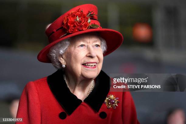 Britain's Queen Elizabeth II reacts during her visit to the aircraft carrier HMS Queen Elizabeth in Portsmouth, southern England on May 22 ahead of...