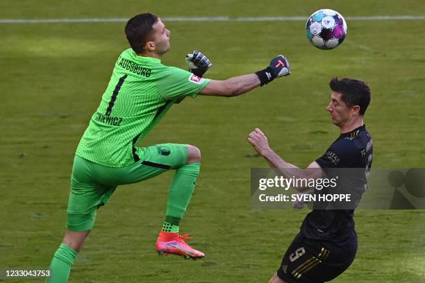 Augsburg's Polish goalkeeper Rafal Gikiewicz and Bayern Munich's Polish forward Robert Lewandowski vie for the ball during the German first division...