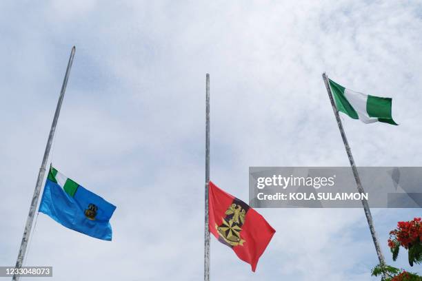 The flags of the Nigerian Army and Nigerian Air Force are seen at half-mast during a military burial ceremony to honour the officers killed in a...