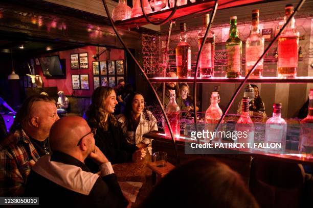 Fully vaccinated customers Julie Brown and Kelsi Teramae gather at the bar inside Risky Business, that was once The Other Door but closed during the...