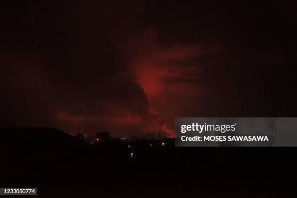 Flames are seen in the outskirts of the city of Goma from the activity of the Nyiragongo volcano on May 22, 2021. - The famous Nyiragongo volcano,...
