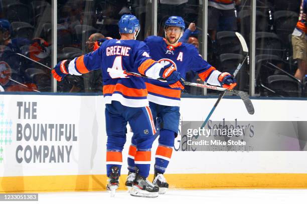 Josh Bailey of the New York Islanders is congratulated by Andy Greene after scoring a goal against the Pittsburgh Penguins during the second period...