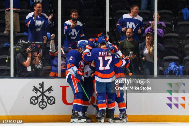 Ryan Pulock of the New York Islanders is congratulated by his teammates after scoring a goal against the Pittsburgh Penguins during the second period...
