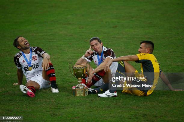 Diego Ribas , Filipe Luis and Diego Alves of Flamengo celebrate with the trophy after winning the Campeonato Carioca 2021 after a match between...