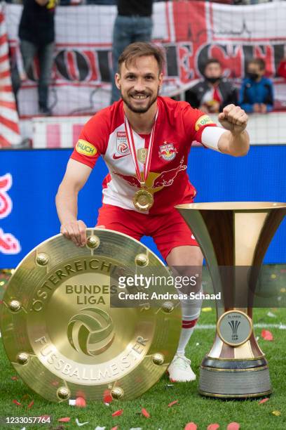 Andreas Ulmer of Red Bull Salzburg celebrates with the trophy for winning the Austrian Soccer Championship and cup after the tipico Bundesliga match...