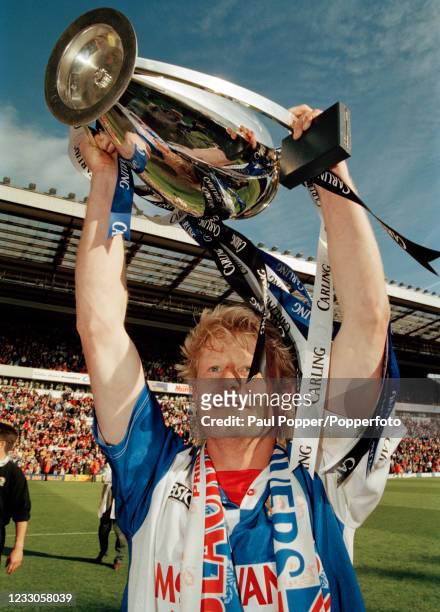 Colin Hendry of Blackburn Rovers celebrates with the trophy after winning the FA Carling Premiership title after the match against Liverpool at...
