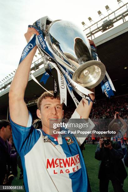 Chris Sutton of Blackburn Rovers celebrates with the trophy after winning the FA Carling Premiership title after the match against Liverpool at...