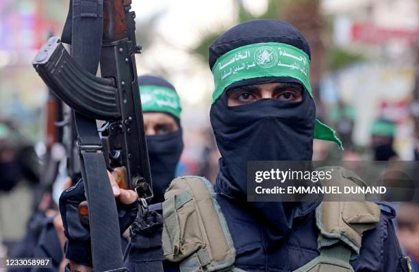 Members of Al-Qassam Brigades, the armed wing of the Palestinian Hamas movement, march in Gaza City on May 22 in commemoration of senior Hamas...