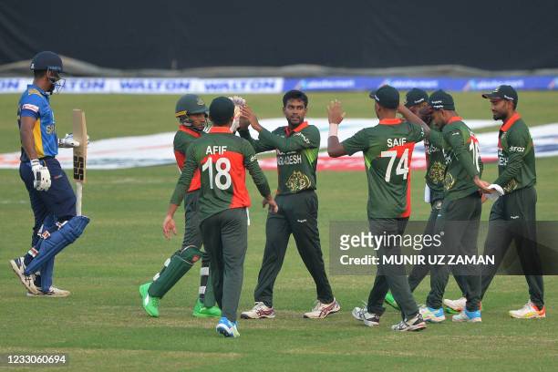 Bangladesh's players celebrate after the dismissal of Sri Lanka's Danushka Gunathilaka during the first one-day international cricket match between...
