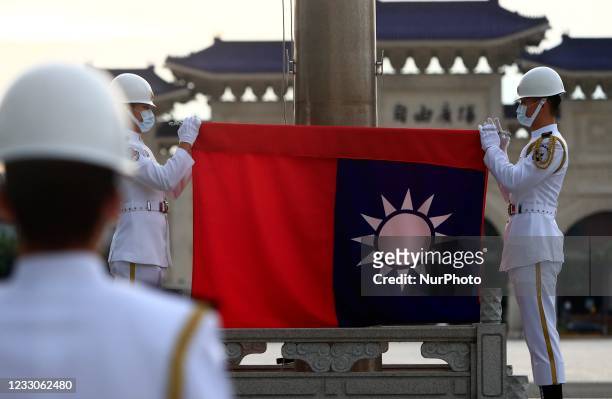 Taiwanese honor guards hold a Taiwan flag at Liberty Square, amid a surge of domestic COVID-19 cases and the rising Taiwan-China tensions, in Taipei,...
