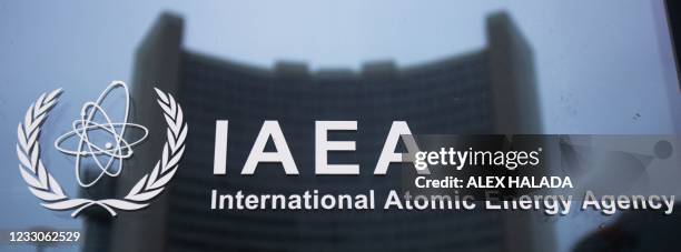 The Vienna office of the UN is reflected in a door with the sign of the International Atomic Energy Agency in the IAEA headquarters in Vienna on May...