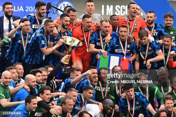 Inter Milan's Italian defender Danilo D'Ambrosio and Inter Milan's Italian midfielder Roberto Gagliardini hold the Scudetto Trophy as Inter players...