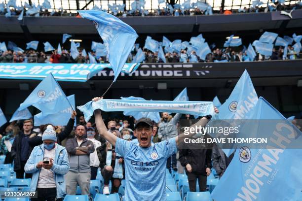 Manchester City fans celebrate during the English Premier League football match between Manchester City and Everton at the Etihad Stadium in...