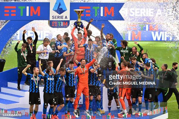 Inter Milan's Slovenian goalkeeper Samir Handanovic lifts the Scudetto Trophy as Inter players and staff celebrate winning the Serie A 2020-2021...
