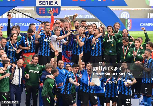 Inter Milan's Sports Coordinator Gabriele Oriali and Inter Milan's Danish midfielder Christian Eriksen lift the Scudetto Trophy as Inter players...