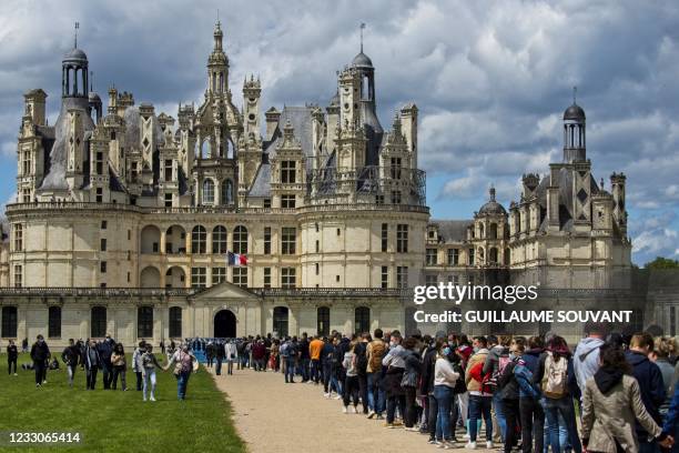 Visitors queue outside of the castle of Chambord, on May 23 in Chambord, central France as France eases-up the measures adopted to curb the spread of...