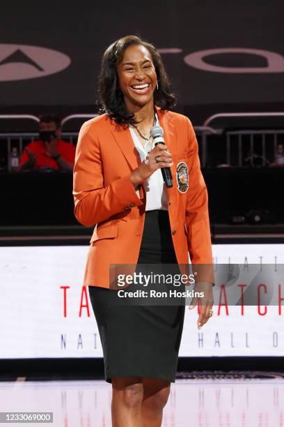 Tamika Catchings receives a trophy for being inducted into the Naismith Memorial Basketball Hall of Fame during the Indiana Fever game against the...