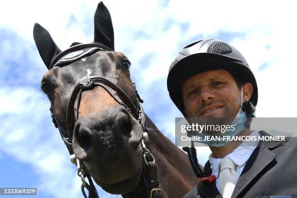 France's rider Nicolas Touzaint poses with his horse "Absolut Gold HDC", prior to the jumping event of "Le Grand National du Lion d'Angers" - a...