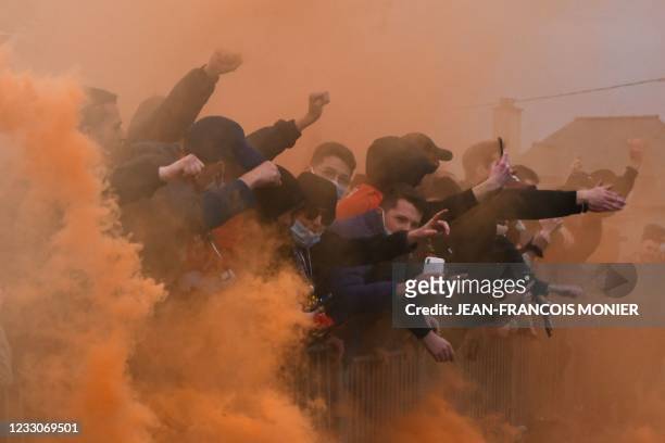 Rennes' supporters light flares prior to the French L1 football match between Stade Rennais Football Club and Nimes Olympique at The Roazhon Park...