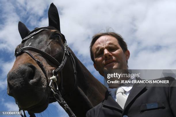 France's rider Nicolas Touzaint poses with his horse "Absolut Gold HDC", prior to the jumping event of "Le Grand National du Lion d'Angers" - a...