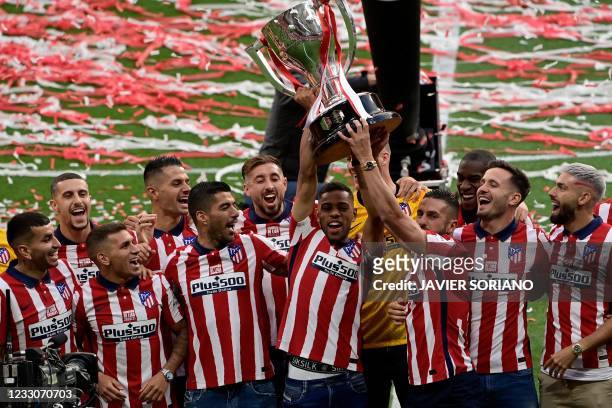Atletico Madrid´s players celebrate with the trophy at the Wanda Metropolitano stadium in Madrid on May 23, 2021 after winning the Spanish Liga...