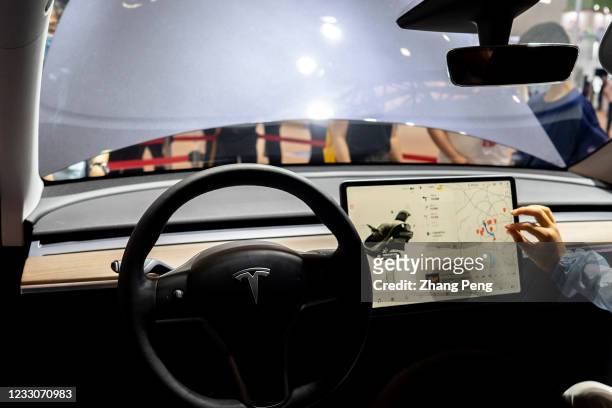 Screen in a Tesla's driver's cab, showing the smart and automatic driving information about the car. TESLA has drawn great public attention in China...