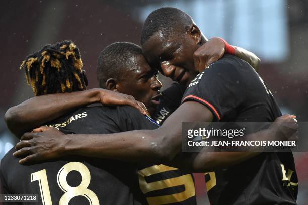 Rennes' French forward Serhou Guirassy celebrates scoring his team's first goal with Rennes' Belgian forward Jeremy Doku and Rennes' Malian defender...