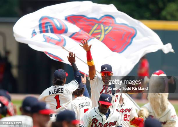 Ronald Acuna Jr. #13 and Ozzie Albies of the Atlanta Braves celebrate their 7-1 win after an MLB game against the Pittsburgh Pirates at Truist Park...