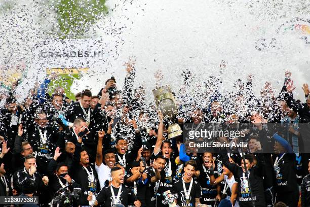Pedro Geromel of Gremio lifts the champions trophy after winning the final of Rio Grande Do Sul State Championship 2021 between Gremio and...