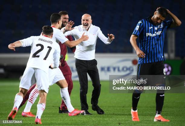 Milan's Italian coach Stefano Pioli celebrates after AC Milan secured their qualification for the Champions League at the end of the Italian Serie A...