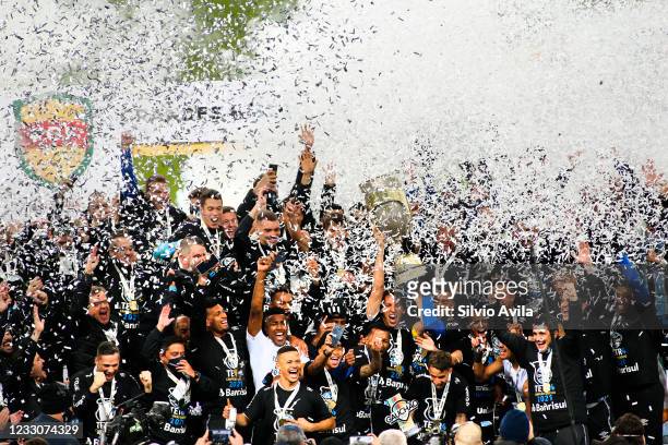Players of Gremio lift the champions trophy after winning the final of Rio Grande Do Sul State Championship 2021 between Gremio and Internacional at...