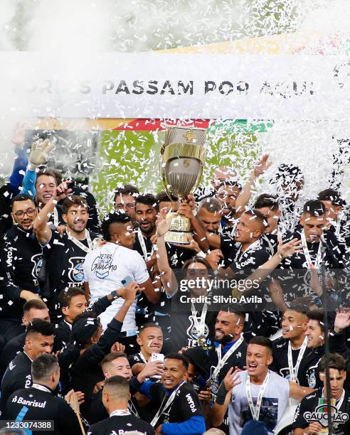 Players of Gremio lift the champions trophy after winning the final of Rio Grande Do Sul State Championship 2021 between Gremio and Internacional at...