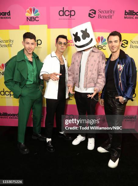 Pictured: Nick Jonas and Joe Jonas of Jonas Brothers, Marshmello, and Kevin Jonas of Jonas Brothers arrive to the 2021 Billboard Music Awards held at...