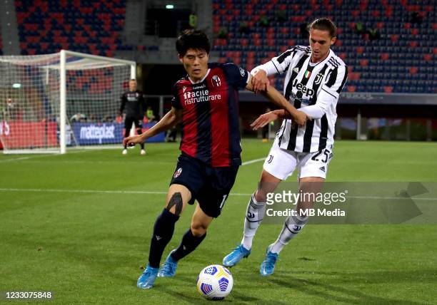 Adrien Rabiot of Juventus FC competes for the ball with Takehiro Tomiyasu of Bologna FC ,during the Serie A match between Bologna FC and Juventus FC...