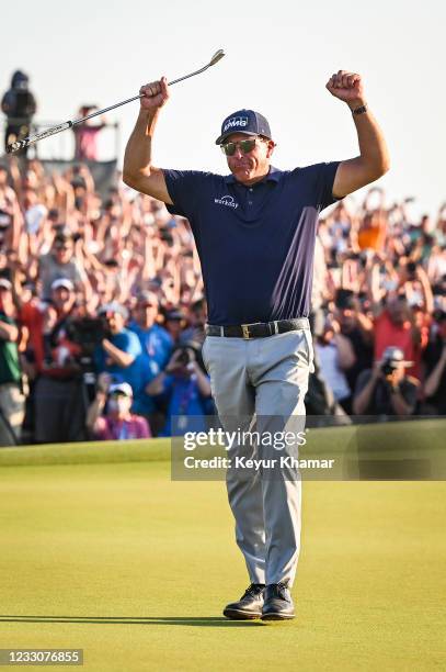 Phil Mickelson raises his arms and celebrates his two stroke victory on the 18th hole green during the final round of the PGA Championship on The...