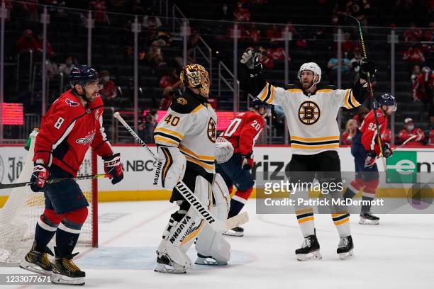 Tuukka Rask of the Boston Bruins celebrates with his teammate Jarred Tinordi after the Bruins defeated the Washington Capitals 3-1 in Game Five of...
