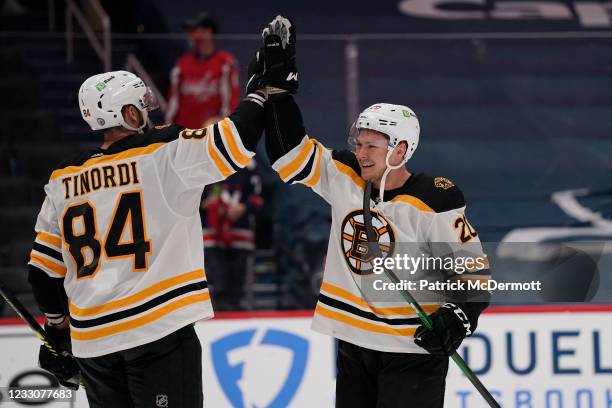 Curtis Lazar of the Boston Bruins celebrates with Jarred Tinordi after defeating the Washington Capitals 3-1 in Game Five of the First Round of the...