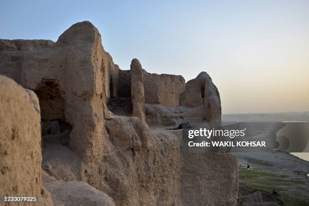 In this photograph taken on March 27 an internally-displaced Afghan man rests inside the ruins of a palace where internally displaced families live,...