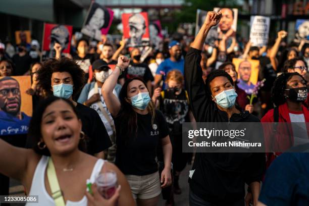 People march in the inaugural remembrance rally and march hosted by the George Floyd Global Memorial, commemorating the first anniversary of his...