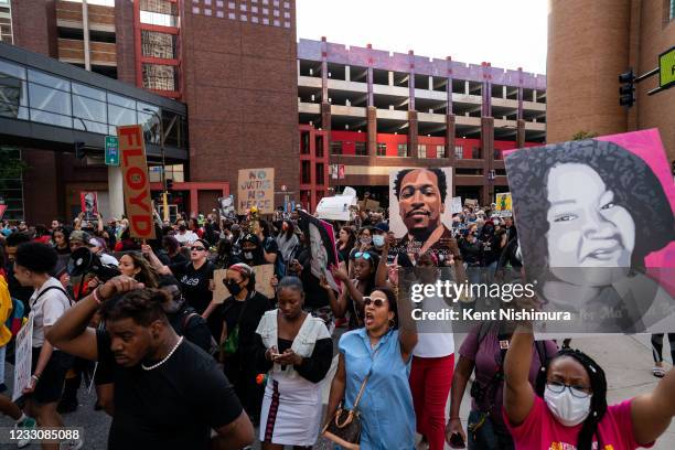 People participate in the inaugural remembrance rally and march hosted by the George Floyd Global Memorial, commemorating the first anniversary of...