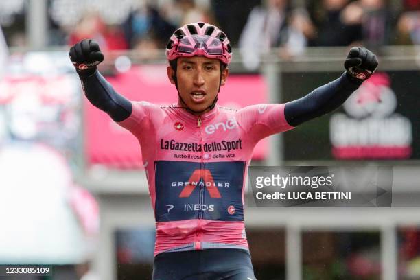 Overall leader Team Ineos rider Colombia's Egan Bernal celebrates as he crosses the finish line to win the 16th stage of the Giro d'Italia 2021...