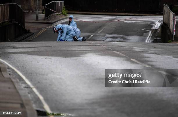 Police forensic officers conduct a finger tip search on Consort Road as they investigate the shooting of Sasha Johnson on May 24, 2021 in London,...