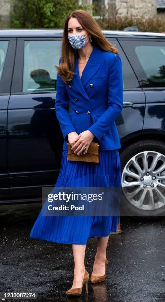 Catherine, Duchess of Cambridge wears a protective face covering to combat the spread of the coronavirus during a visit to a violence reduction unit,...