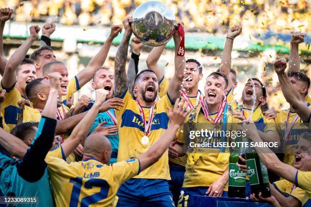 Broendby's Anthony Jung and teammates celebrate with the trophy after winning the Danish Football Championship Superliga after the Super League...