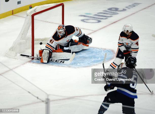 Mark Scheifele of the Winnipeg Jets scores against Mike Smith of the Edmonton Oilers in Game Four of the First Round of the 2021 Stanley Cup Playoffs...