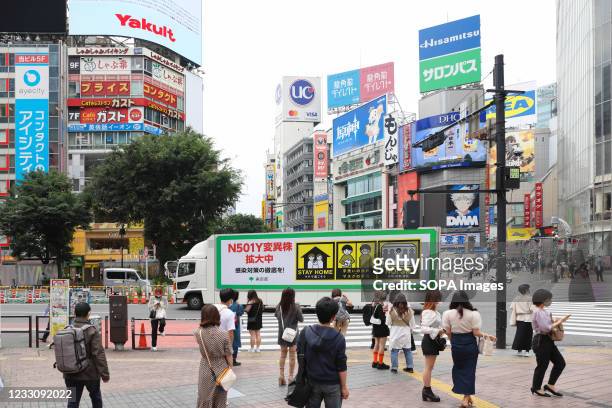 Coronavirus variation is spreading, please refrain from going outside! Is written on a truck organized by the Tokyo City Government to inform the...